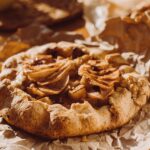 A delicious homemade apple galette on rustic brown paper, perfect for breakfast or dessert.